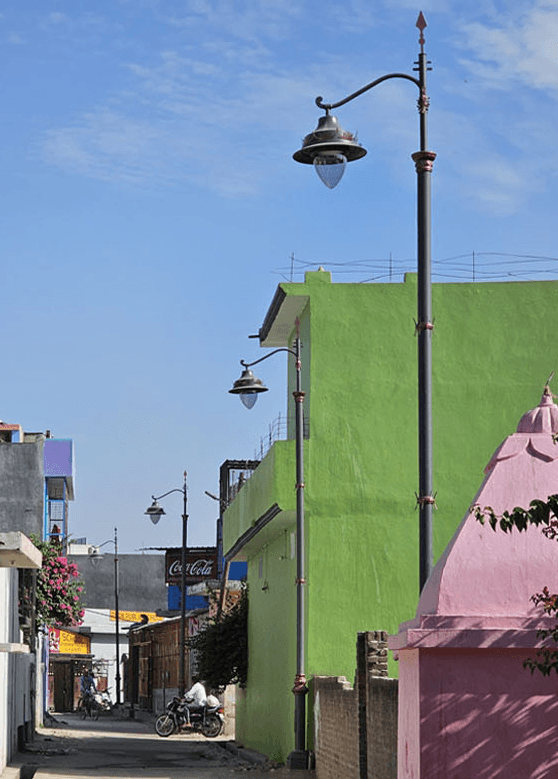 Heritage teardrop street lanterns on decorative columns along a street