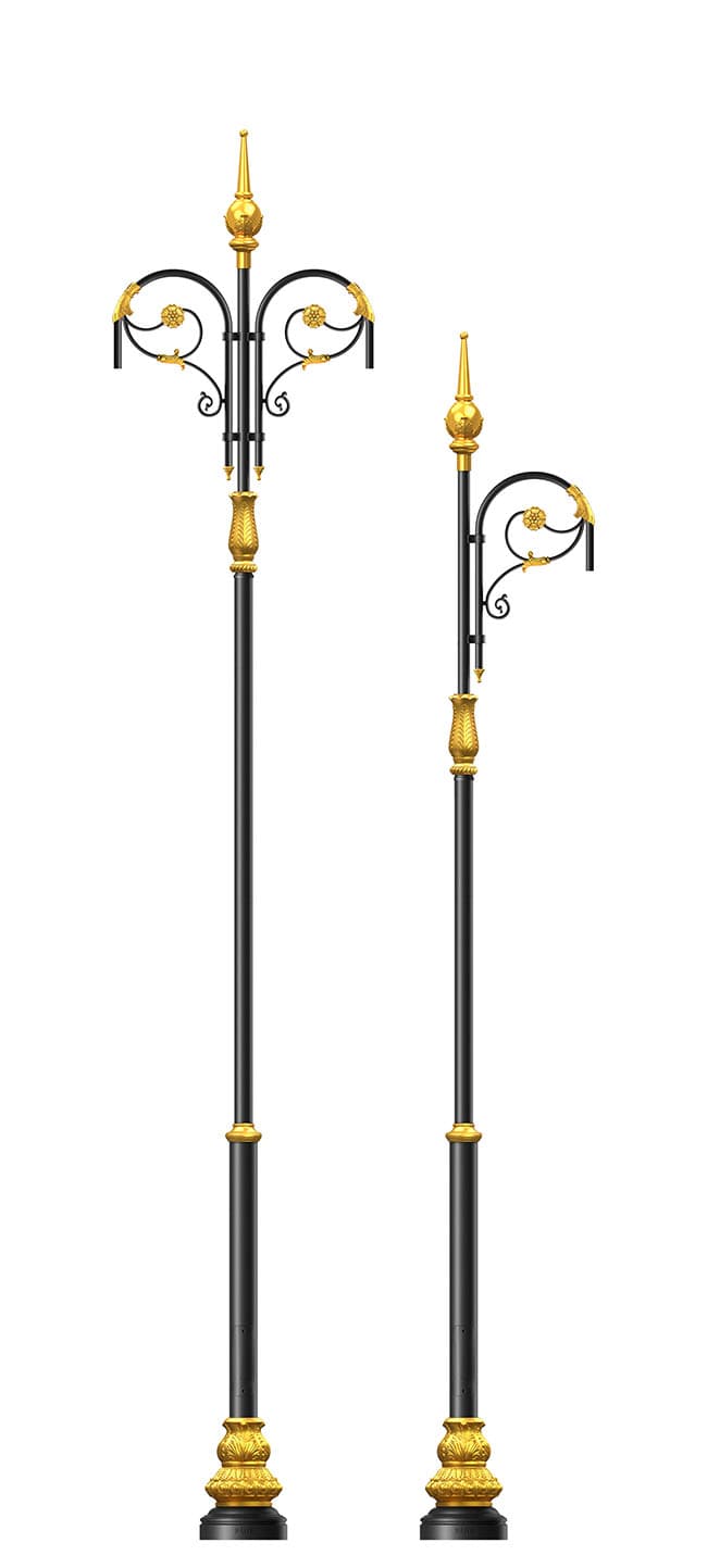 Two ornamental cast decorative lighting columns with gilded finials on a plain background
