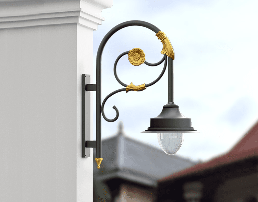 Ornamental scrollwork wall bracket lantern in black and gold on a white pillar