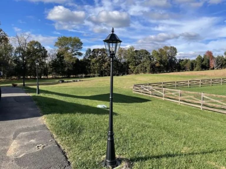 Single lantern-style post-top light on a landscaped lawn