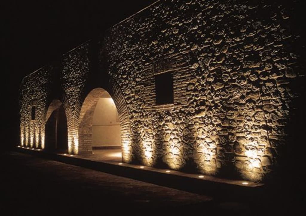 Warm light grazing a stone façade